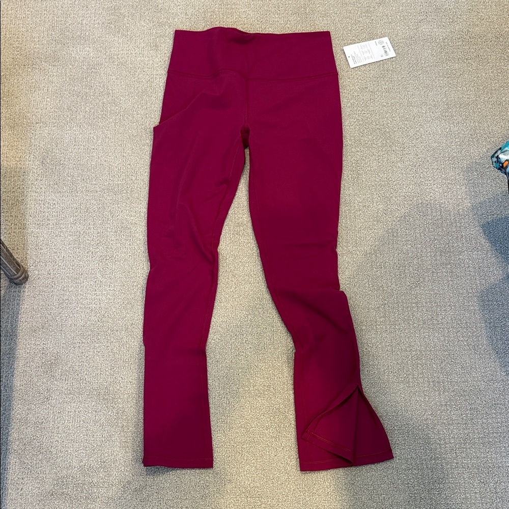 NWT Athleta Elation split slim flare Power of she leggings. Size large.